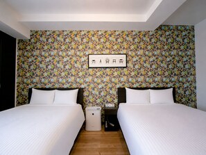 A hotel room with two beds, a nightstand, a waste bin, and a wall with a floral pattern. - Randor Residence Tokyo Annex (Arakawa-ku)