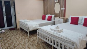 A hotel room with two beds, a small bedside table, a mirror, and a sliding door. - Pplace (Bangkok)