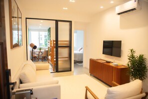 Relax in this stylish living room with a sofa set, flat-screen TV, and console table.