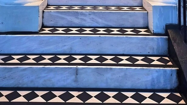 A black door with the number 111, flanked by two potted plants, leading to a staircase with a black and white checkered pattern. - *NEW* Notting Hill - It's The One One One! (2) (London)
