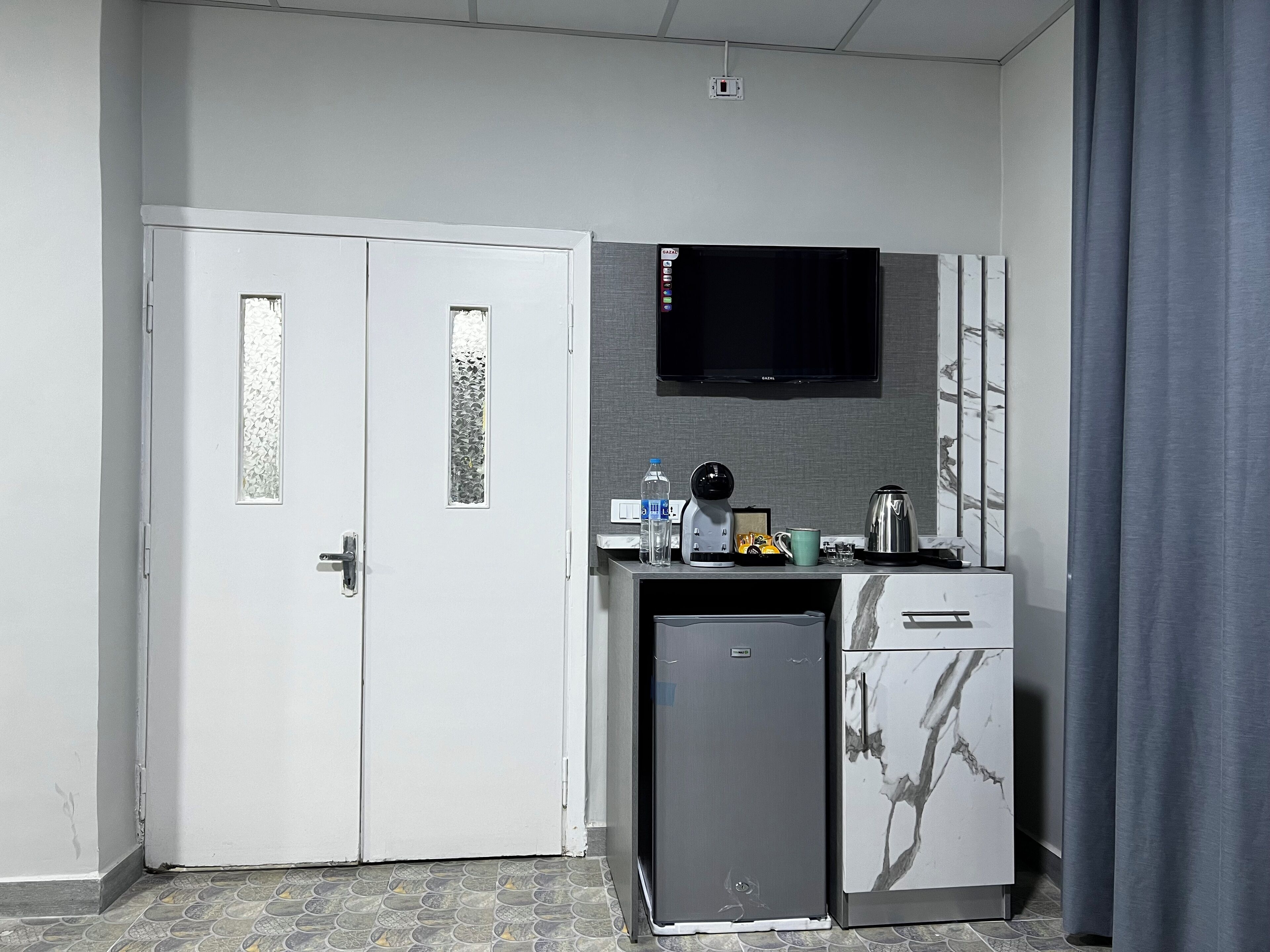 Habitación triple clásica, patio | Área de sala de estar | Televisión 