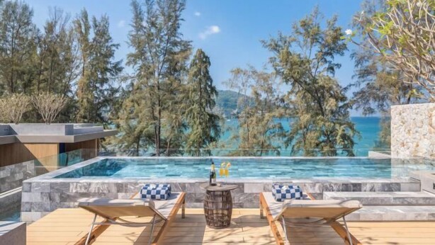 A poolside area with lounge chairs, a hot tub, and a view of the sea. - Twinpalms MontAzure Phuket (Phuket)