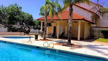 Relax by the pool surrounded by palm trees and a tranquil atmosphere.