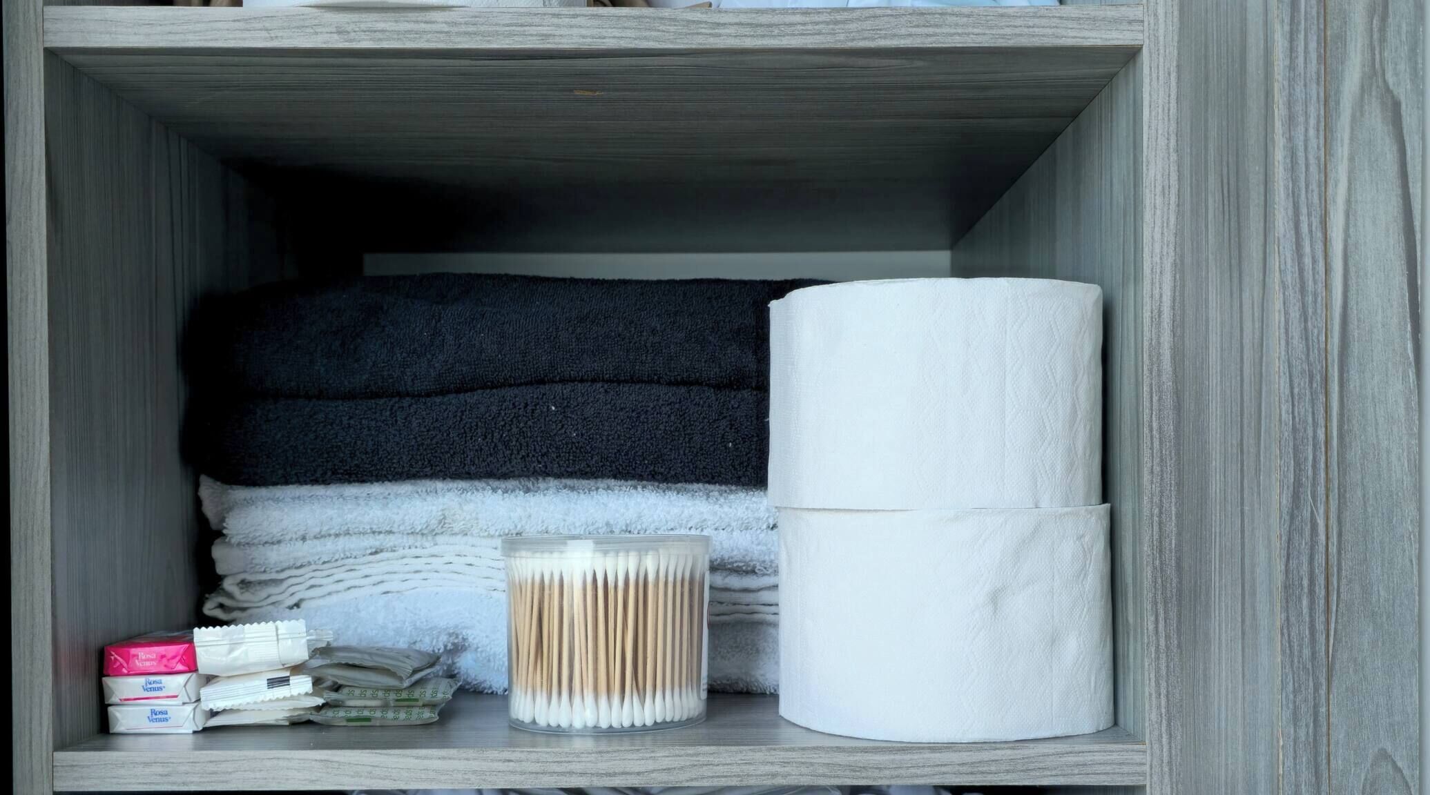 A storage box containing toiletries and a tissue roll.