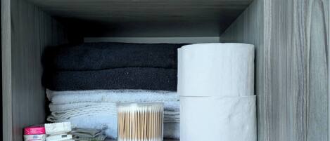 A storage box containing toiletries and a tissue roll.