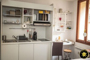 Fridge, microwave, stovetop, coffee/tea maker