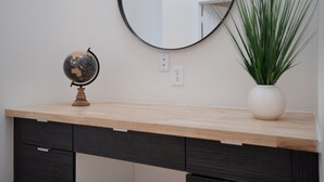 A desk with a globe, a mirror, and a potted plant. - Cozy/Modern King Suite in Houston Texas (Houston)