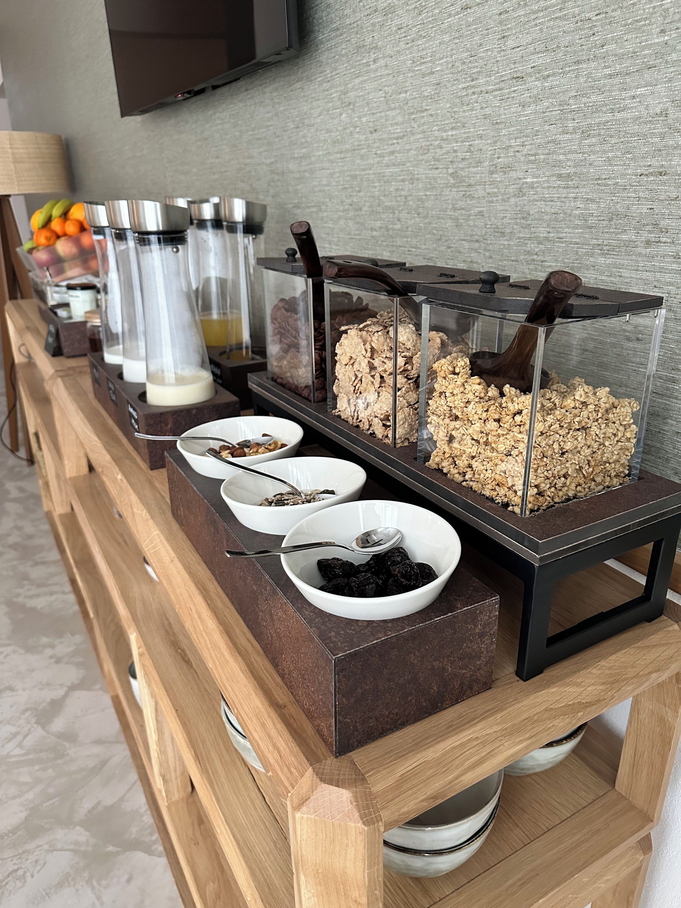 A breakfast buffet with various food items and a coffee machine.