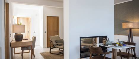 A modern living room with a dining area, a sofa, and a TV.
