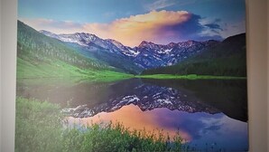 A landscape painting of a mountain range with a lake reflecting the mountains. - Aspen Inn - Summer Suite (Creede)