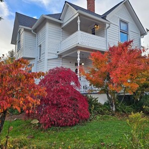 A two-story house with a porch and a chimney. - Hedges House - Upstairs (Independence)