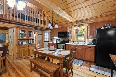 Charming cabin that has beds for 8 guests, hot tub, electric fireplace, firepit