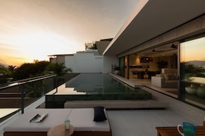 A modern outdoor living area with a pool, seating, and a view of the property. - Muscat 3-Bedroom Villa with Beach Access (Koh Samui)