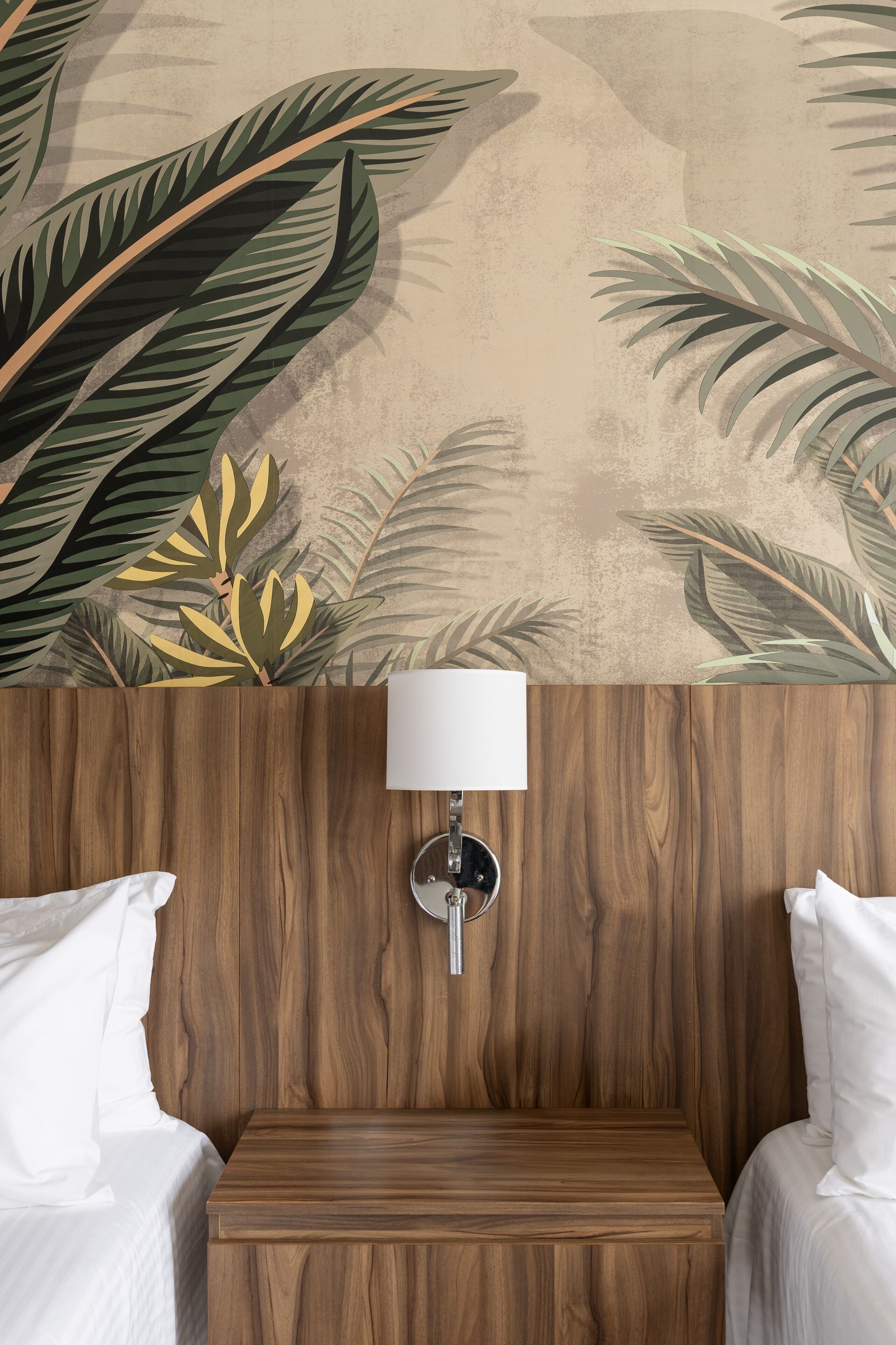 A hotel room with a wooden headboard, a wall-mounted lamp, and a bed with white bedding.