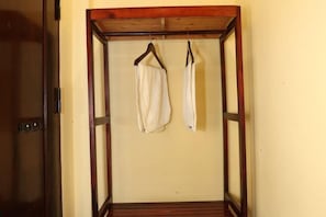 Une pièce dotée d’un espace suspendu avec une structure en bois pour ranger les vêtements.