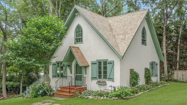 A two-story house with a steeply pitched roof, green shutters, and a brick entrance. - Head of Pond House (Water Mill)
