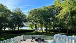 A swimming pool with lounge chairs and a white fence. - Head of Pond House (Water Mill)