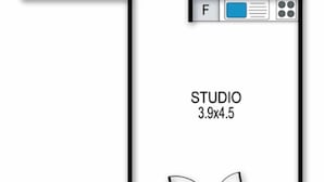 A floor plan of a studio apartment measuring 3.9x4.5 meters, featuring a kitchenette, a bathroom, and a living area with a large window. - White Crystal 112- ski-in ski-out (Mount Hotham)