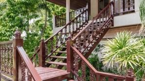 A wooden staircase with ornate railings leading to a building. - Orchid Pool Villa Lavish Villa in Perfect Location (Phuket)