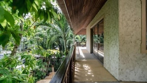 A covered outdoor corridor with a pool, surrounded by lush greenery. - Orchid Pool Villa Lavish Villa in Perfect Location (Phuket)