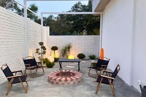 An outdoor patio with a fire pit, seating, and potted plants. - The Luxurious 1256, Forest Flow Villa (Pegoh)