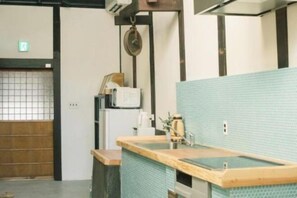 Un baño con mostrador de madera y pared de azulejos azules.