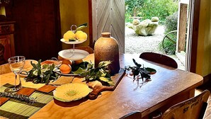 A dining table set with plates, glasses, and a vase. - Streamside Country Manor - Peaceful Spacious Country Retreat Near Hobbiton (Richmond Downs)