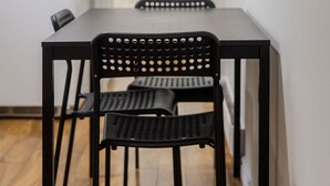 A modern kitchen with a black table and chairs, a white refrigerator, and a wooden floor. - Spacious & Trendy 2BR – Heart of Montreal (Montréal)
