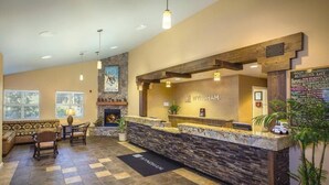 A reception area with a stone counter, wooden beams, and a sign that reads "WYNDHAM." - Charming 2-bedroom condo close to ski resort with WiFi in beautiful Zephyr Cove (Zephyr Cove)
