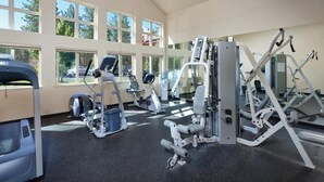 A gym with various exercise machines, large windows, and a view of the outdoors. - Charming 2-bedroom condo close to ski resort with WiFi in beautiful Zephyr Cove (Zephyr Cove)
