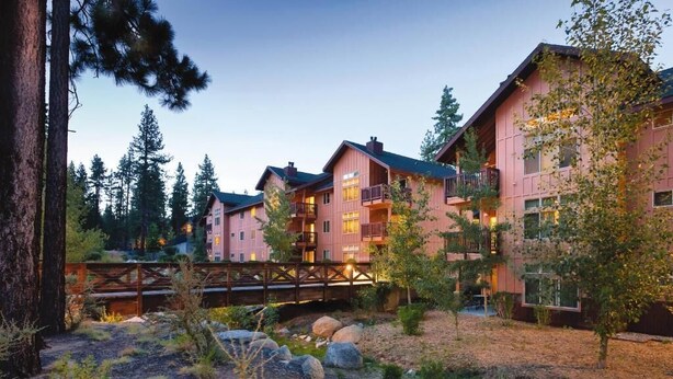A multi-story hotel with a rustic exterior, featuring balconies and a wooden bridge in the foreground. - Charming 2-bedroom condo close to ski resort with WiFi in beautiful Zephyr Cove (Zephyr Cove)