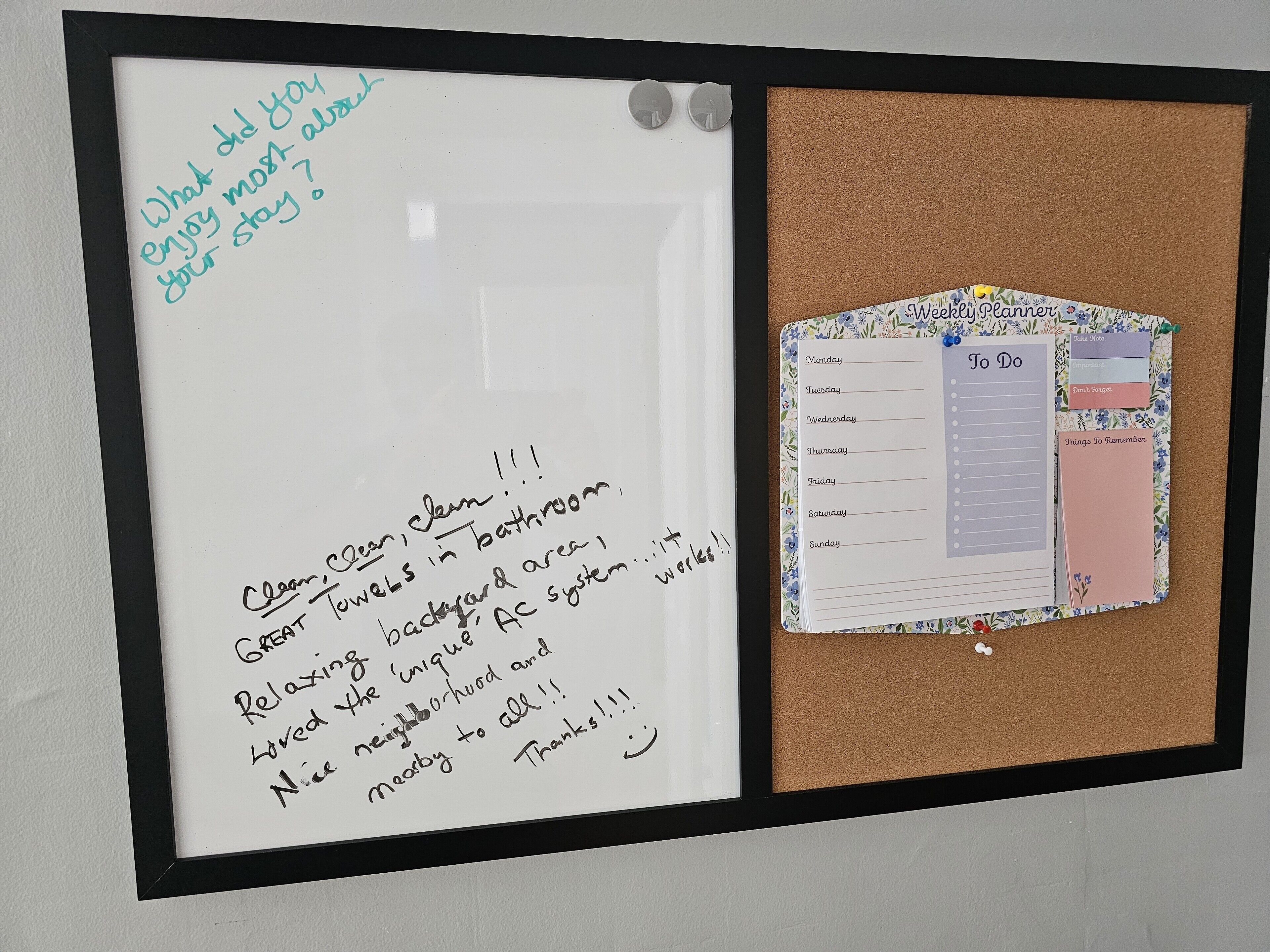 A bulletin board with a handwritten note and a planner.