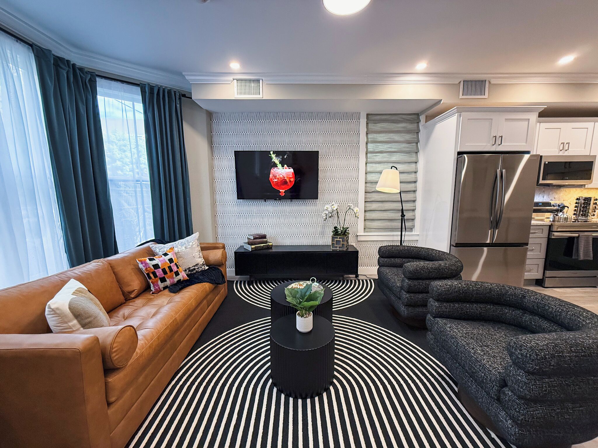 Un salon moderne avec un canapé, une table basse et un téléviseur fixé au mur.