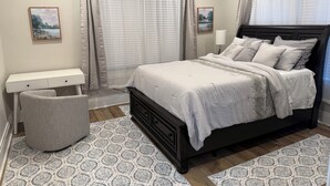A bedroom with a bed, bedside tables, a desk, and a chair. - Fully renovated Charming 2-bedroom with full kitchenin amazing at1423 Madison av (Montgomery)
