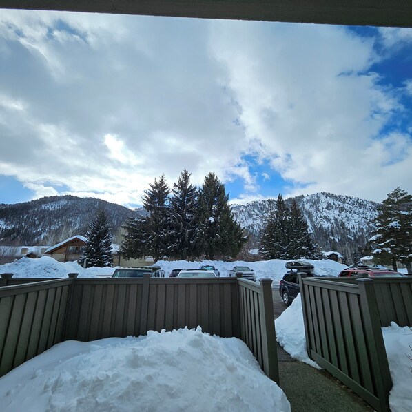 A snowy mountain landscape with a wooden fence in the foreground. - Skier's Paradise in the winter, bikers/hikers paradise in the summer! (Ketchum)