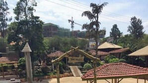 A pathway leading to a covered area labeled "The Valley," surrounded by landscaped gardens and a construction site in the background. - Rwizi View Hotel Mbarara (Mbarara)