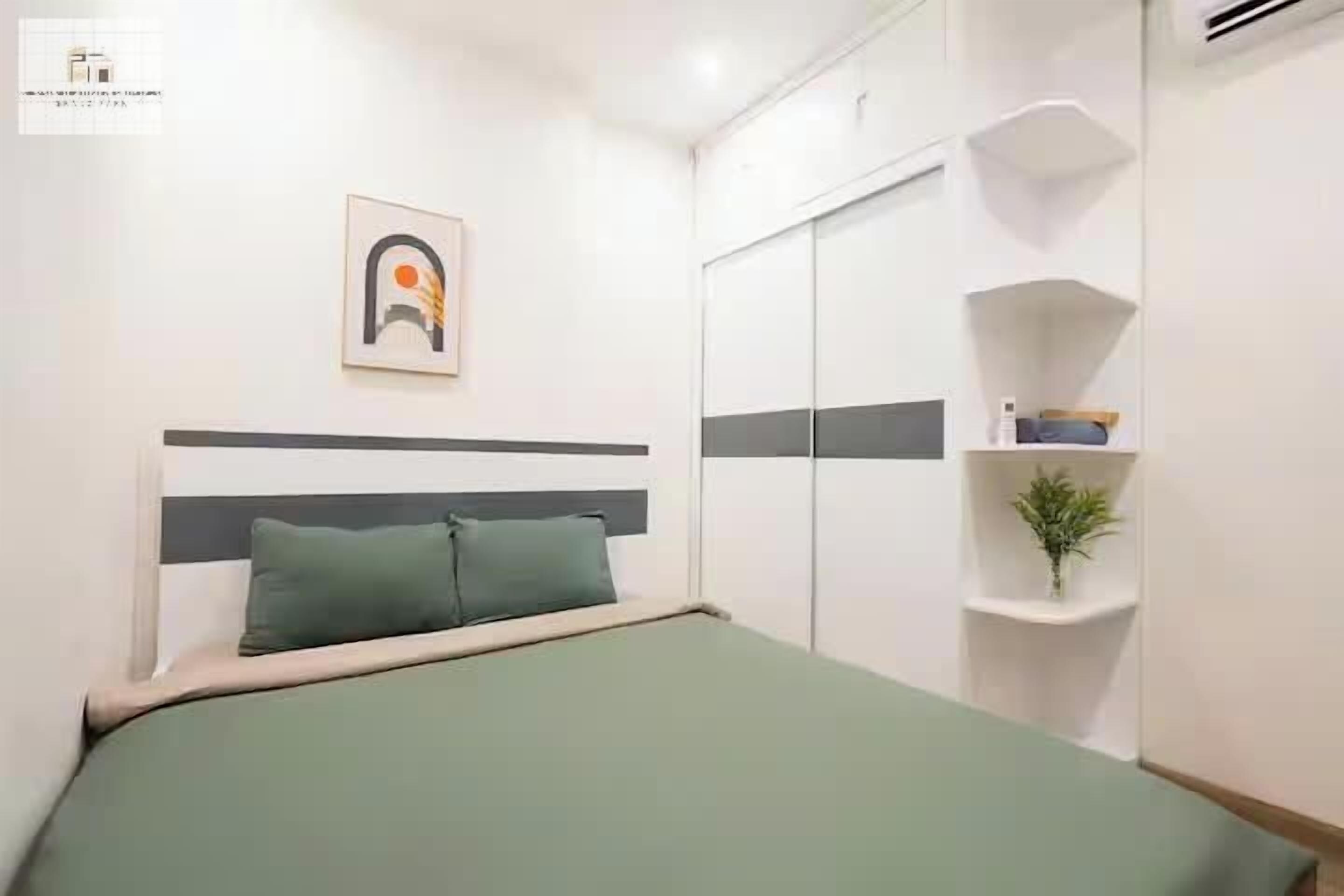Une chambre à coucher avec un lit, une armoire et une étagère sur laquelle est posée une plante.