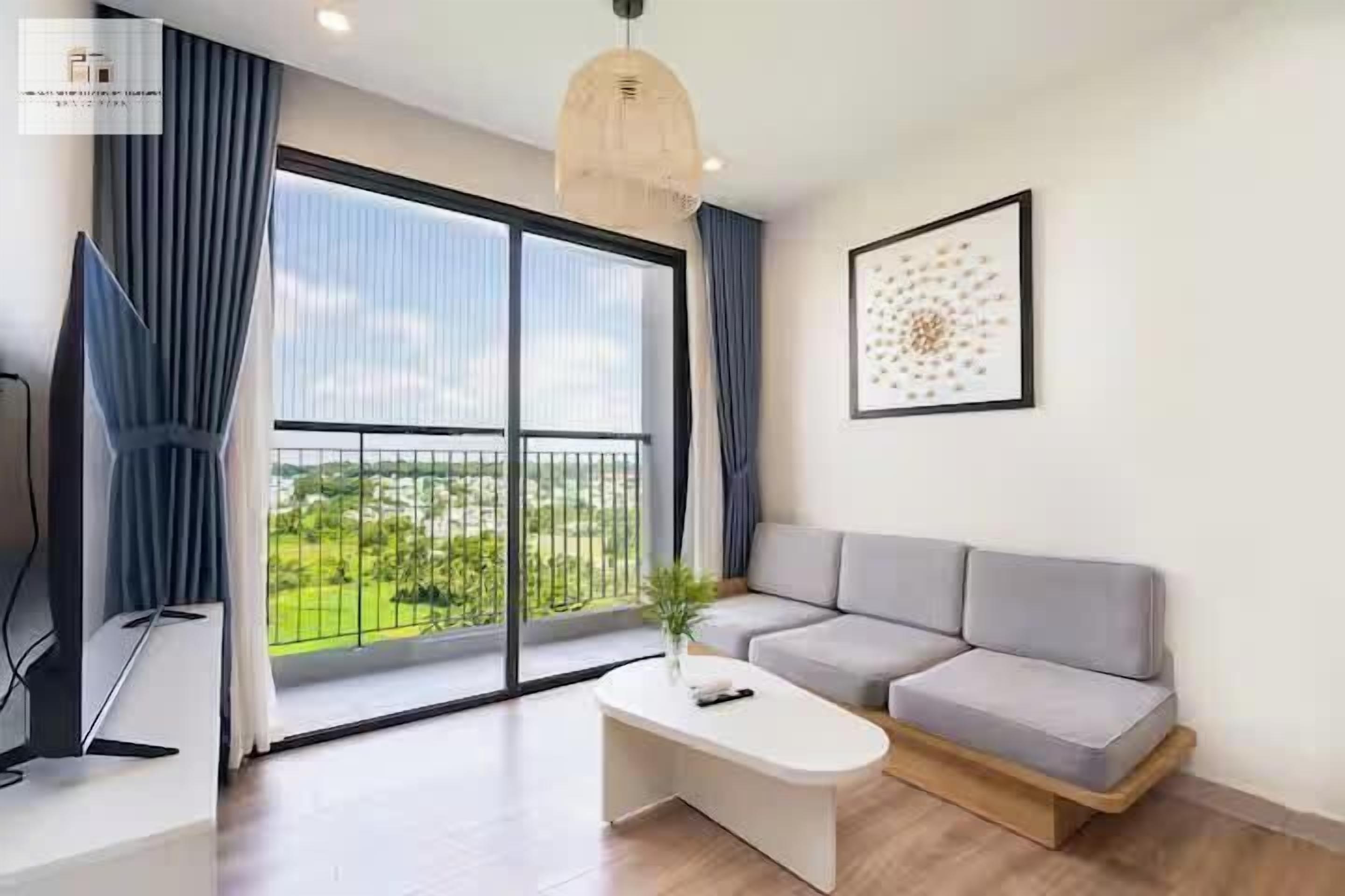 A modern living room with a sofa, a coffee table, and a TV.