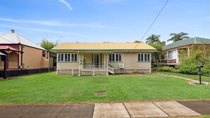 A single-story house with a front porch, a small front yard, and a mailbox.
