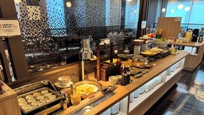 A buffet setup with various food items and utensils. - HOTEL ROUTE-INN Grand NAGOYA FUJIGAOKA EKIMAE (Nagoya)