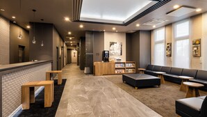 A modern lobby with a reception desk, seating area, and a skylight. - HOTEL ROUTE-INN Grand NAGOYA FUJIGAOKA EKIMAE (Nagoya)