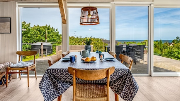 A dining area with a table set for four, overlooking a lush landscape. - "Shaya" - 325m from the sea by Interhome (Allingåbro)