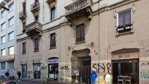 A building with multiple storefronts, including a visible restaurant named 'Siena.' - GuestHost - Bright APT with balcony- Milan Piazzale Loreto (Milano)