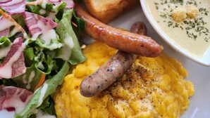 A plate with scrambled eggs, sausage, toast, and a side salad with dressing. - Hotel BRS Hakodate Goryokaku Tower (Hakodate)