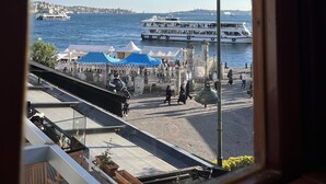 A view of a waterfront area with a clear sky, a promenade, and boats on the water. - Levant Pension de Luxe  (Istanbul)