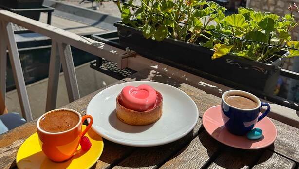 A table with a pastry, a cup of coffee, and a plate with a strawberry. - Levant Pension de Luxe  (Istanbul)