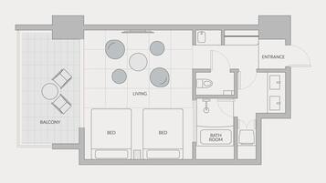 A floor plan of a hotel with a balcony, two bedrooms, a living room with a dining area, a bathroom, and an entrance.