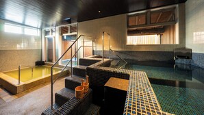 A spa area with a hot tub, a small pool, and a set of stairs leading to a wooden deck. - HOTEL MEGURI (Usa)