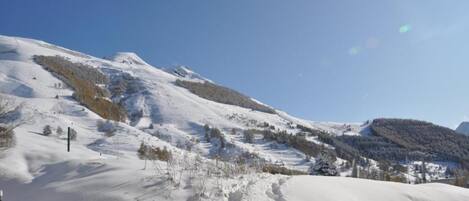 A snow-covered mountain landscape with clear skies.