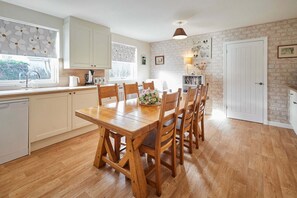 Enjoy meals with family and friends at the dining table in this well-appointed kitchen.